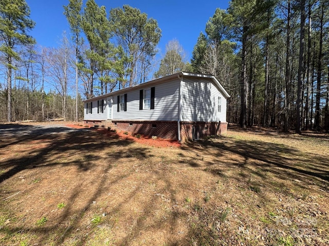 view of side of home featuring crawl space