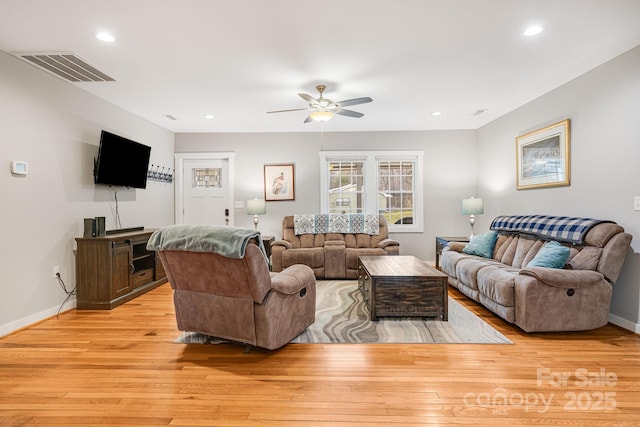 living area with light wood-style flooring, recessed lighting, visible vents, a ceiling fan, and baseboards