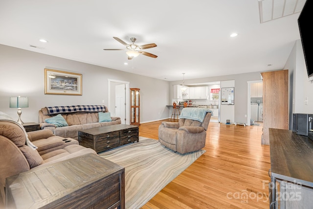 living area with light wood-type flooring, visible vents, ceiling fan, and recessed lighting