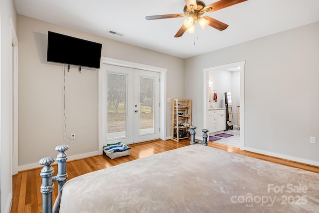 bedroom with wood finished floors, visible vents, baseboards, access to exterior, and french doors