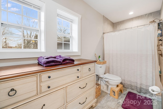 full bathroom with a shower with shower curtain and toilet