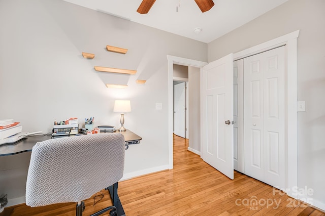 office with light wood-style flooring, baseboards, and a ceiling fan