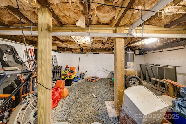 unfinished basement featuring gas water heater