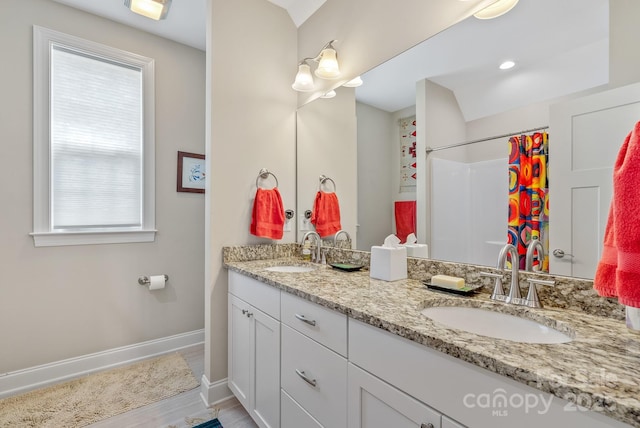 50 Rose Creek Rd, Leicester, NC 28748 - bathroom with baseboards, a sink, wood finished floors, and double vanity