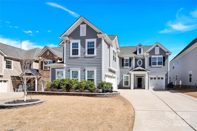 view of front of house with concrete driveway and an attached garage