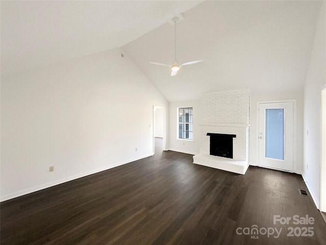 unfurnished living room with ceiling fan, high vaulted ceiling, dark wood-type flooring, a fireplace, and visible vents