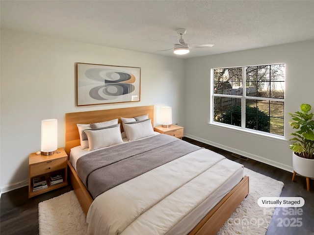 bedroom featuring dark wood-style floors, ceiling fan, and baseboards