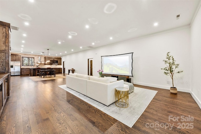 13124 Lemmond Dr, Matthews, NC 28105 - living room featuring dark wood finished floors, recessed lighting, and ornamental molding