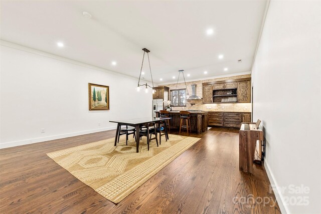 13124 Lemmond Dr, Matthews, NC 28105 - dining area featuring dark wood-style flooring, recessed lighting, and ornamental molding