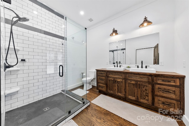 13124 Lemmond Dr, Matthews, NC 28105 - bathroom with wood finished floors, double vanity, and a stall shower