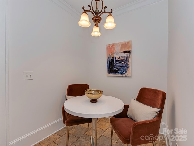 dining room with an inviting chandelier, baseboards, and crown molding