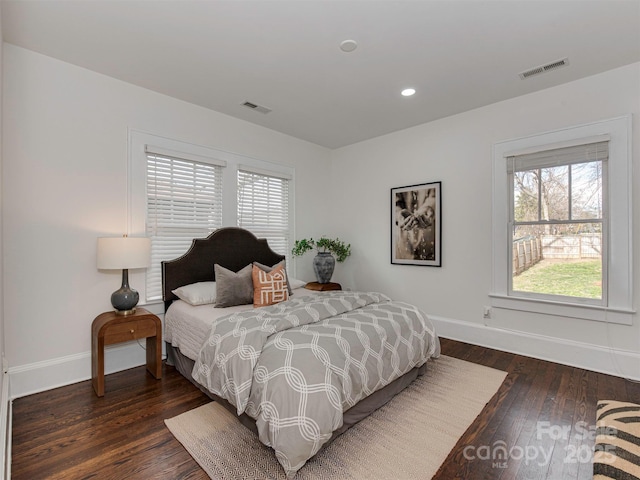 bedroom featuring wood-type flooring, visible vents, baseboards, and recessed lighting