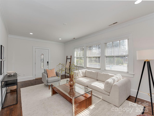 living area with baseboards, wood finished floors, and crown molding