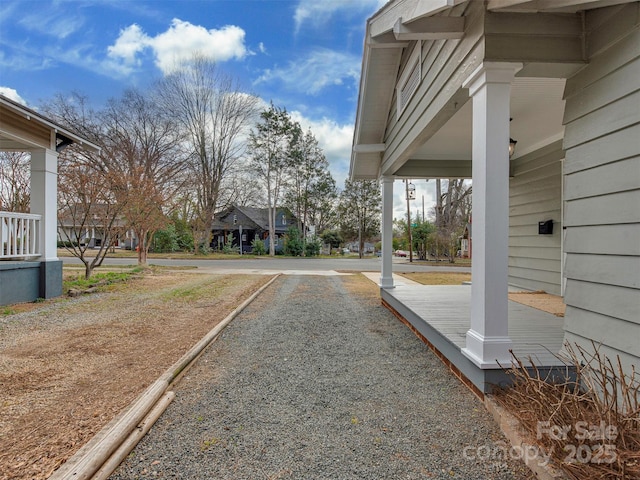 view of yard featuring covered porch