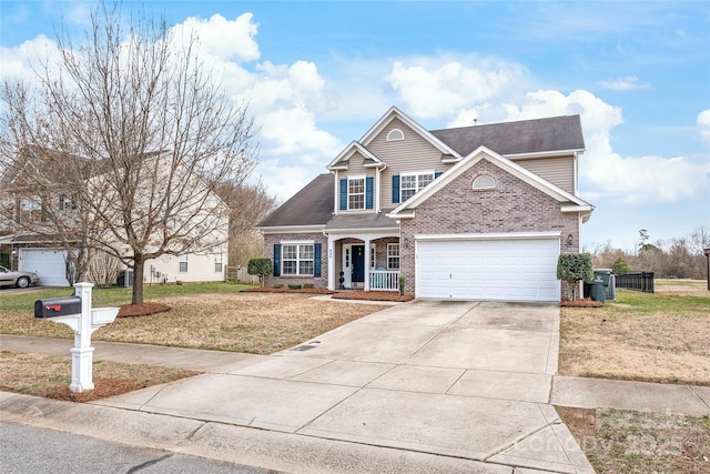 traditional-style home with concrete driveway, brick siding, and a front lawn