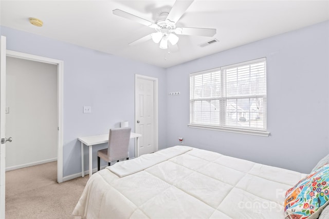 bedroom featuring carpet floors, baseboards, visible vents, and a ceiling fan