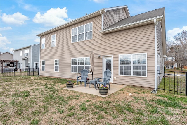 back of house featuring a patio, a lawn, and a fenced backyard