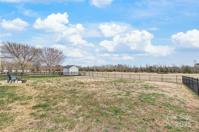 view of yard featuring a rural view and fence