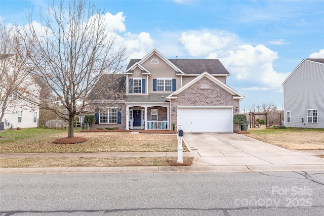 traditional-style home with concrete driveway, brick siding, fence, and a front lawn