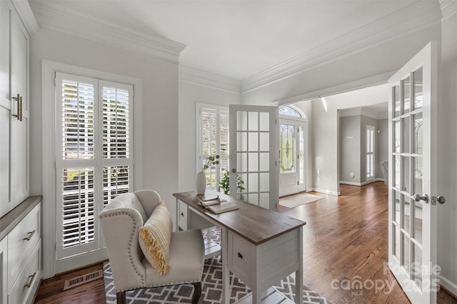 office area with baseboards, visible vents, ornamental molding, wood finished floors, and french doors