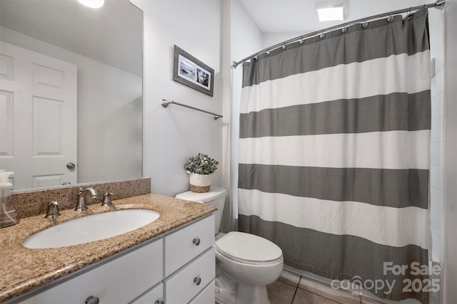 bathroom featuring a shower with curtain, vanity, toilet, and tile patterned floors