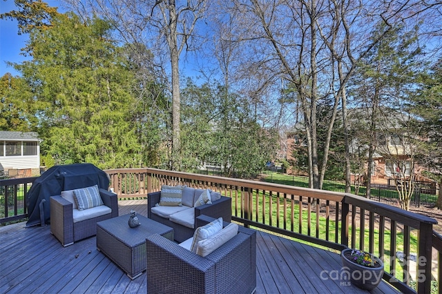 wooden deck with fence and an outdoor living space