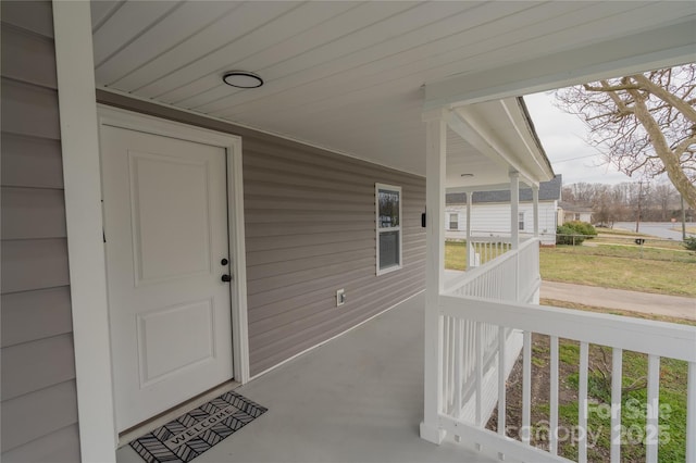 view of exterior entry featuring a porch