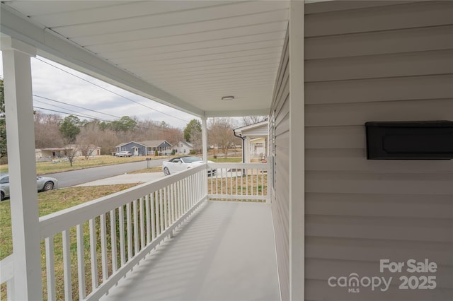 balcony with a residential view and a porch