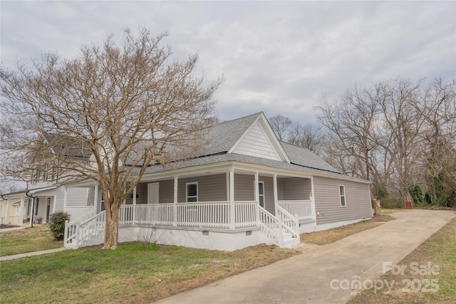 farmhouse inspired home with crawl space, a porch, a front lawn, and a shingled roof