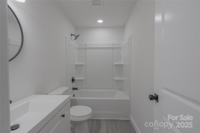 full bath featuring shower / washtub combination, visible vents, toilet, vanity, and wood finished floors