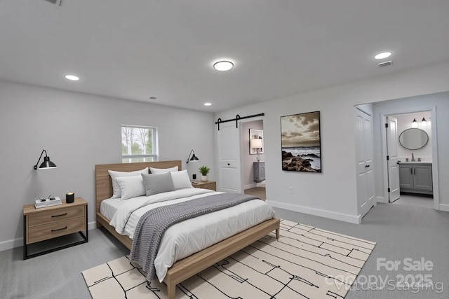 116 11th St, Spencer, NC 28159 - bedroom featuring a barn door, connected bathroom, light carpet, and recessed lighting