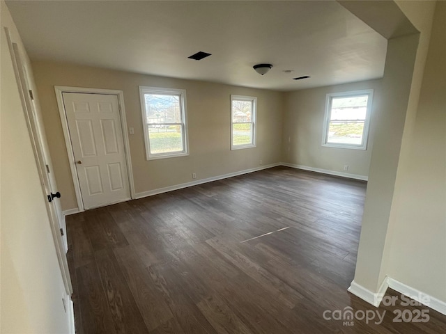 interior space featuring dark wood-style floors and baseboards