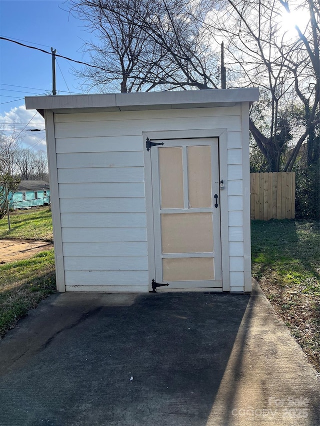 view of shed featuring fence