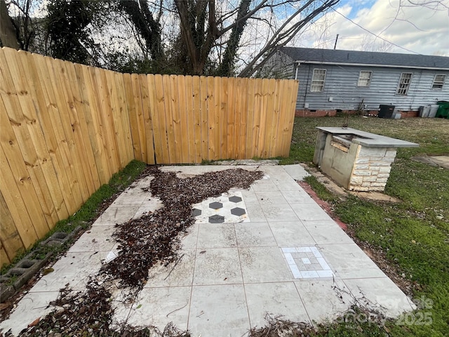 view of patio / terrace featuring fence