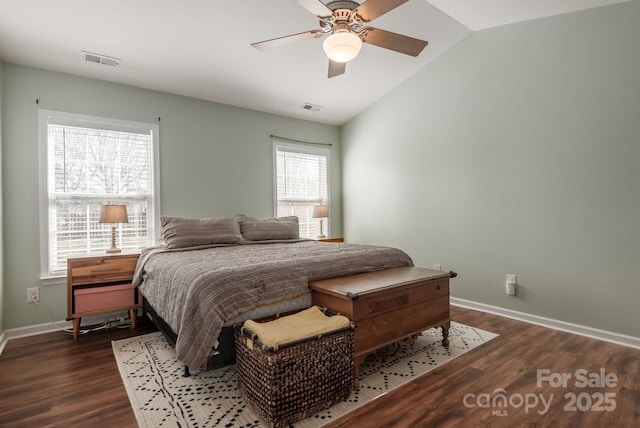 bedroom featuring baseboards, visible vents, vaulted ceiling, and dark wood-style flooring