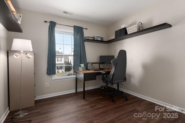 home office featuring visible vents, baseboards, and wood finished floors