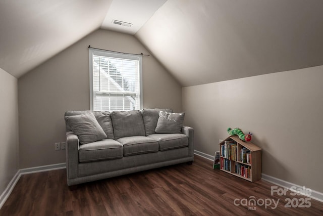 living area with vaulted ceiling, visible vents, dark wood finished floors, and baseboards