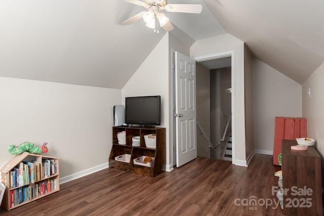 additional living space with lofted ceiling, a ceiling fan, baseboards, and wood finished floors