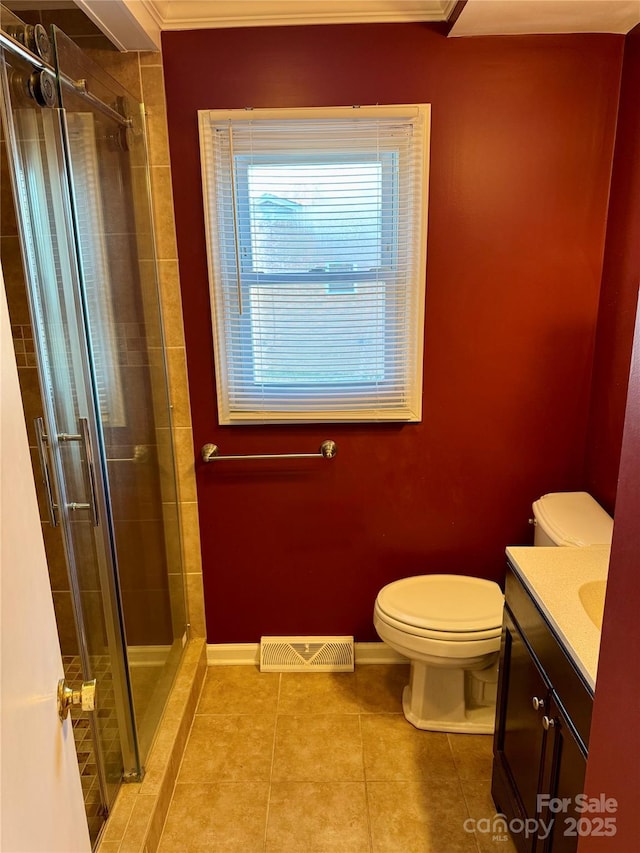 full bathroom with toilet, a stall shower, vanity, and visible vents