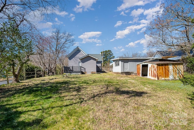 view of yard featuring an outbuilding and a deck