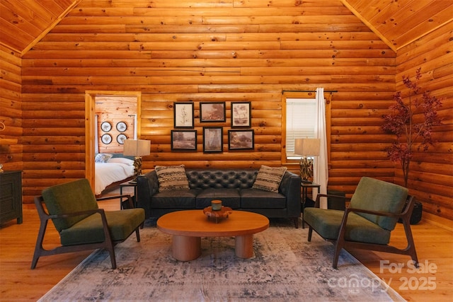 living area featuring high vaulted ceiling, wooden ceiling, wood finished floors, and log walls