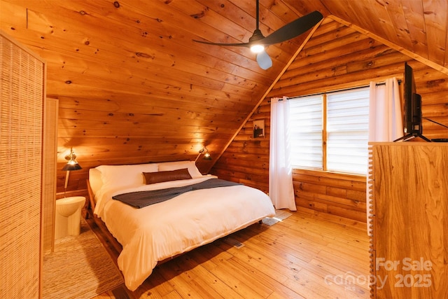 bedroom featuring hardwood / wood-style flooring, wood ceiling, wooden walls, and vaulted ceiling