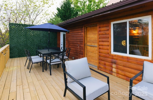 deck with outdoor dining area