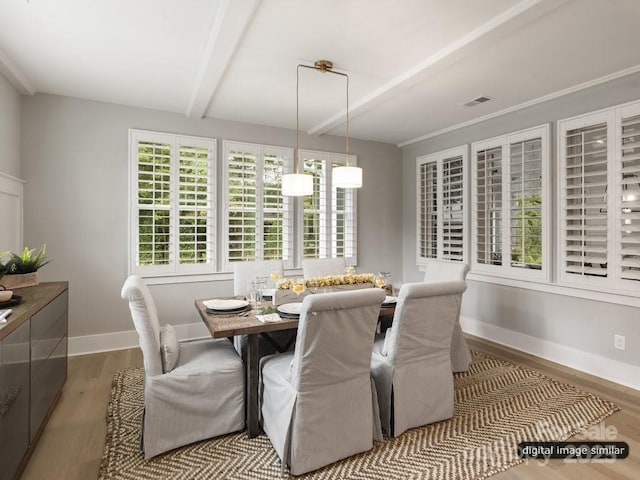 dining area with visible vents, beam ceiling, baseboards, and wood finished floors