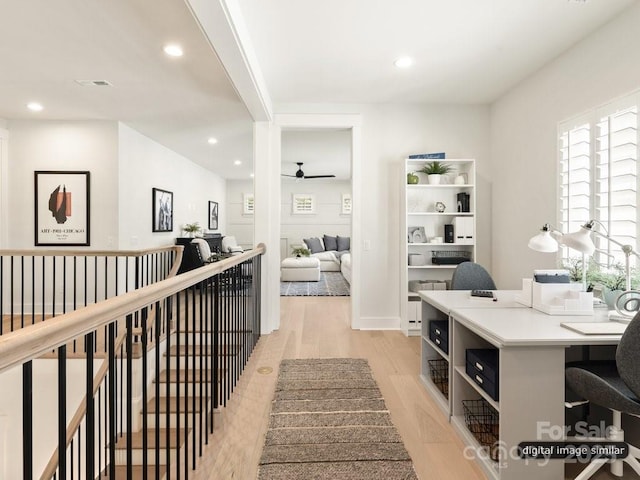 hallway featuring recessed lighting, an upstairs landing, visible vents, and light wood-style floors