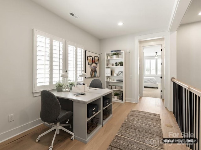 home office with light wood-type flooring, baseboards, and recessed lighting