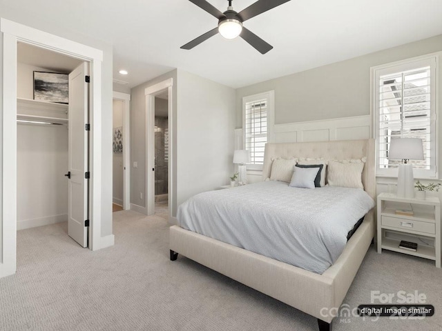 bedroom featuring light carpet, ensuite bath, ceiling fan, a spacious closet, and recessed lighting