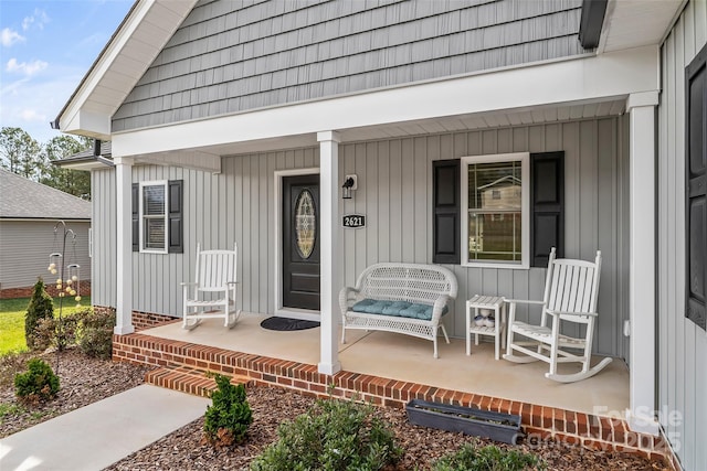 entrance to property featuring a porch and board and batten siding