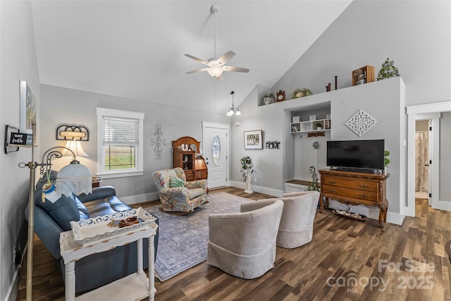 living area featuring baseboards, ceiling fan, high vaulted ceiling, and wood finished floors