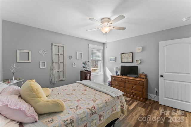 bedroom featuring dark wood-style floors and a ceiling fan